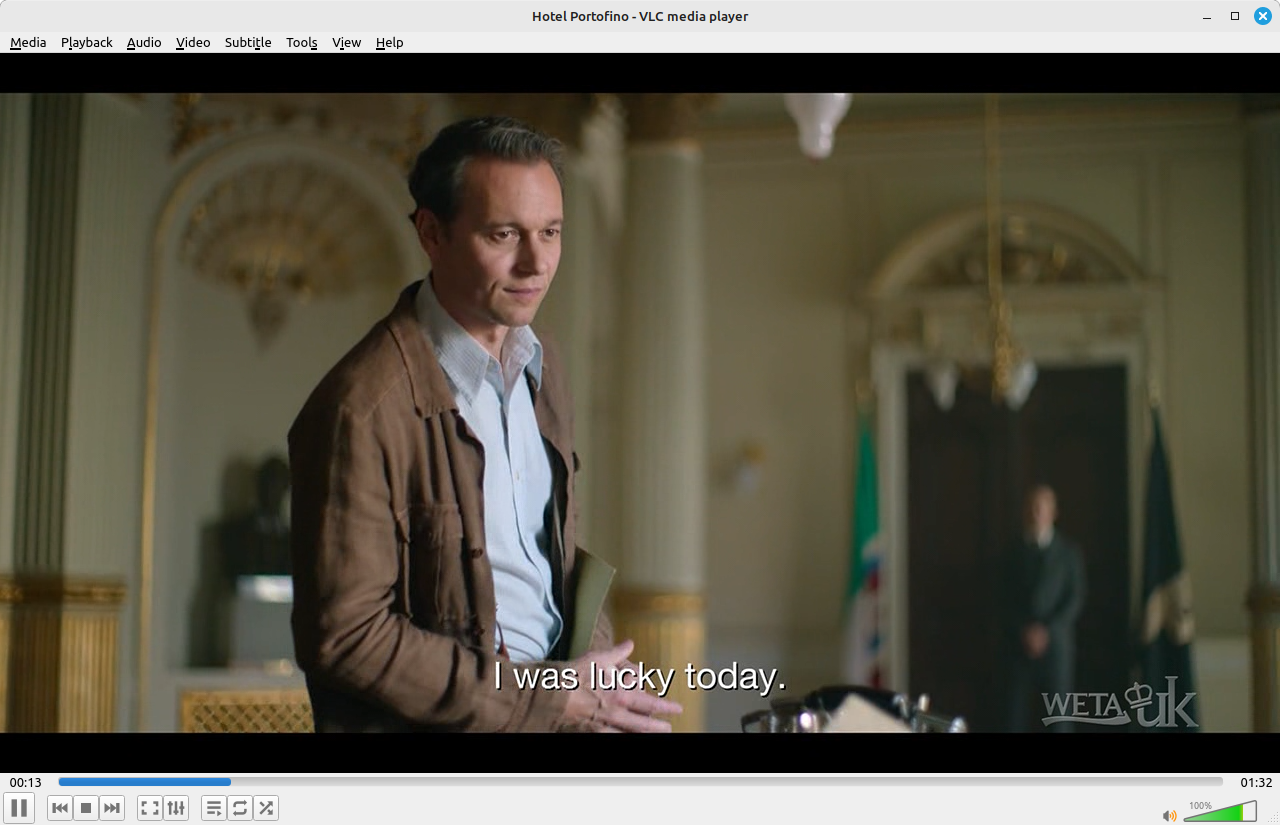 Screenshot from live TV showing a man standing in front of a desk.